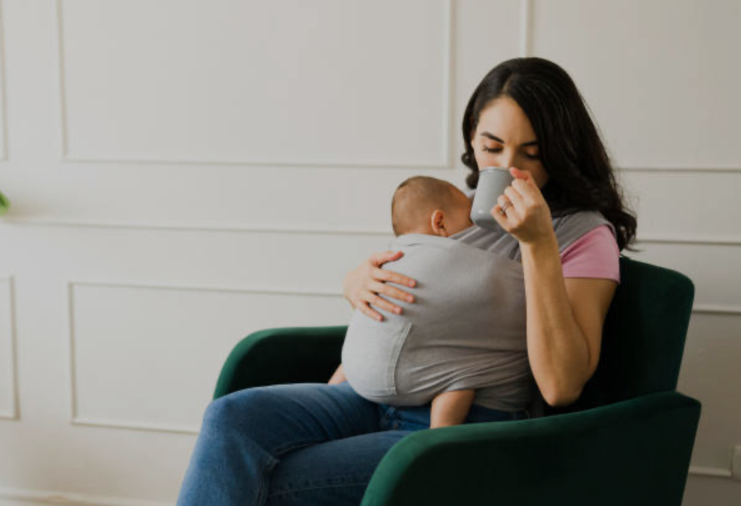 A photo of a cozy scene of a mother in maternity loungewear cuddling her newborn, representing the Kindred Bravely and Momcozy product recommendations.