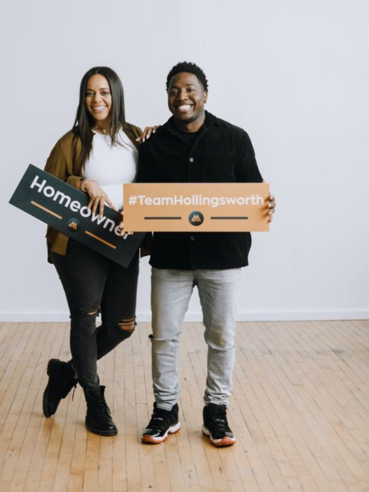 Real Estate Agents holding Homeowner signs