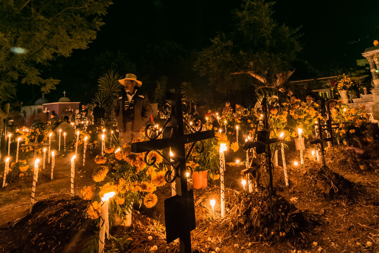 Graves lit by hundreds of candles on Day of the Dead night in the cemetery of Santa Mar&iacute;a Atzompa, Oaxaca