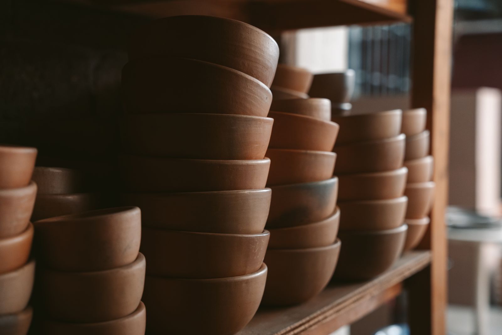 Stacks of clay bowls on the shelves of a pottery workshop in Oaxaca Stacks of clay bowls on the shelves of a pottery workshop in Oaxaca