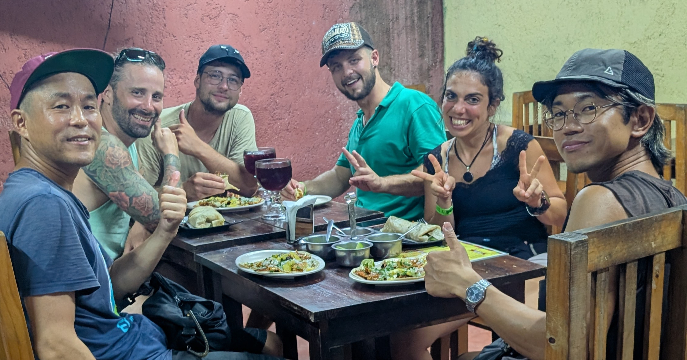 People sitting at a table with food at taqueria los poblanos in valladolid, mexico People sitting at a table with food at taqueria los poblanos in valladolid, mexico