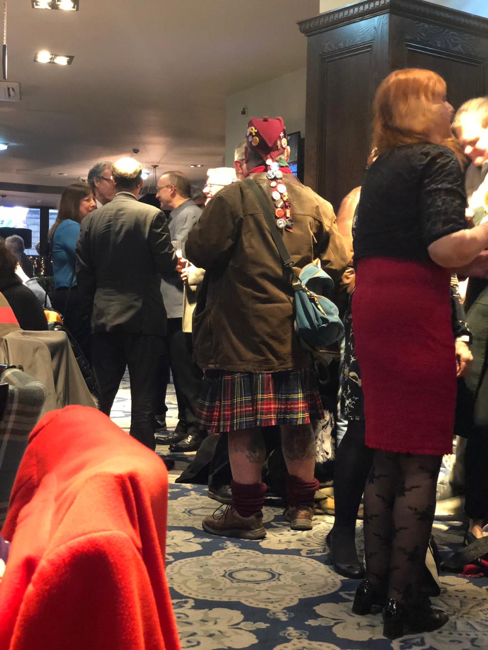 A man wearing a kilt in a pub in Edinburgh Scotalnd during Christmas time A man wearing a kilt in a pub in Edinburgh Scotalnd during Christmas time