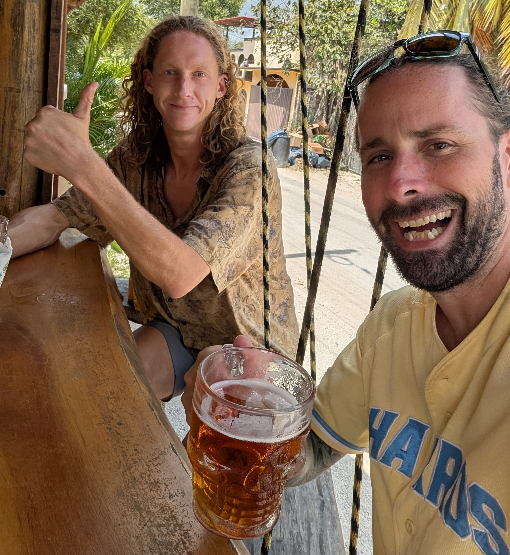 A friend of mine and I sitting at a bar outside in Bacalar Mexico