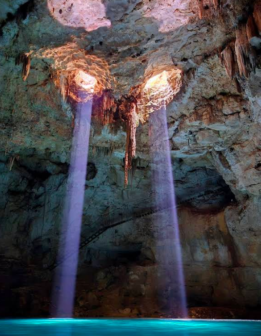 light coming through and hitting the water at Xnuuk cenote in valladolid mexico