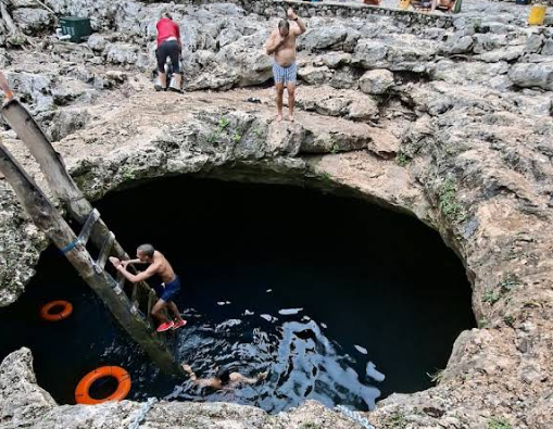 entrance of cenote calavera tulum in mexico
