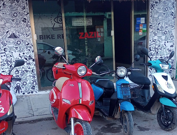 scooters and bicycles in front of zazil biek and scooter rental in tulum mexico