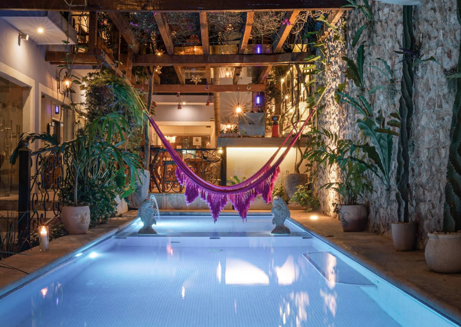 pool with a hammock hanging over it at night at le muuch hotel in valladolid mexico pool with a hammock hanging over it at night at le muuch hotel in valladolid mexico