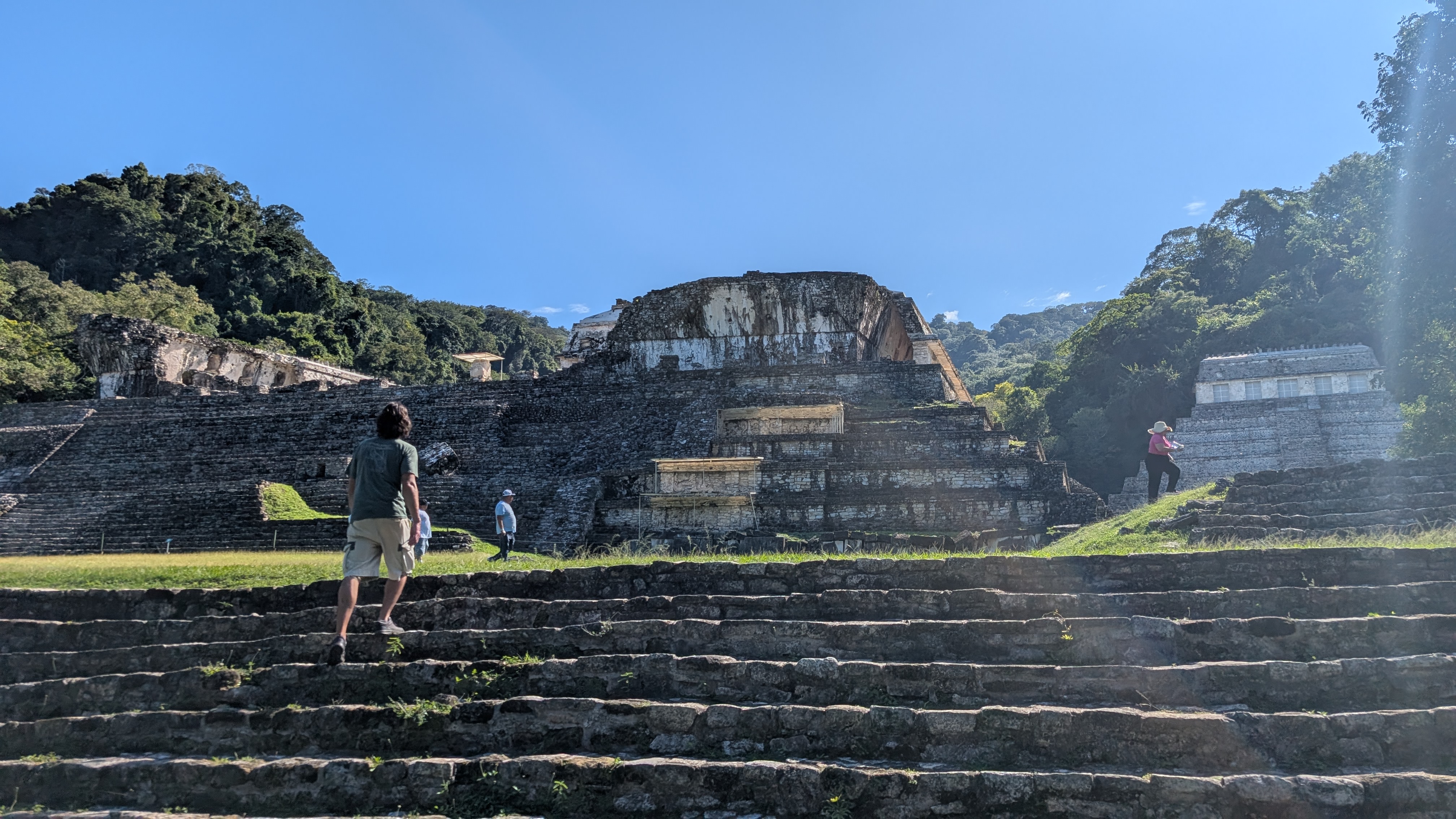 Climbing the stone steps of a Maya temple at Palenque ruins