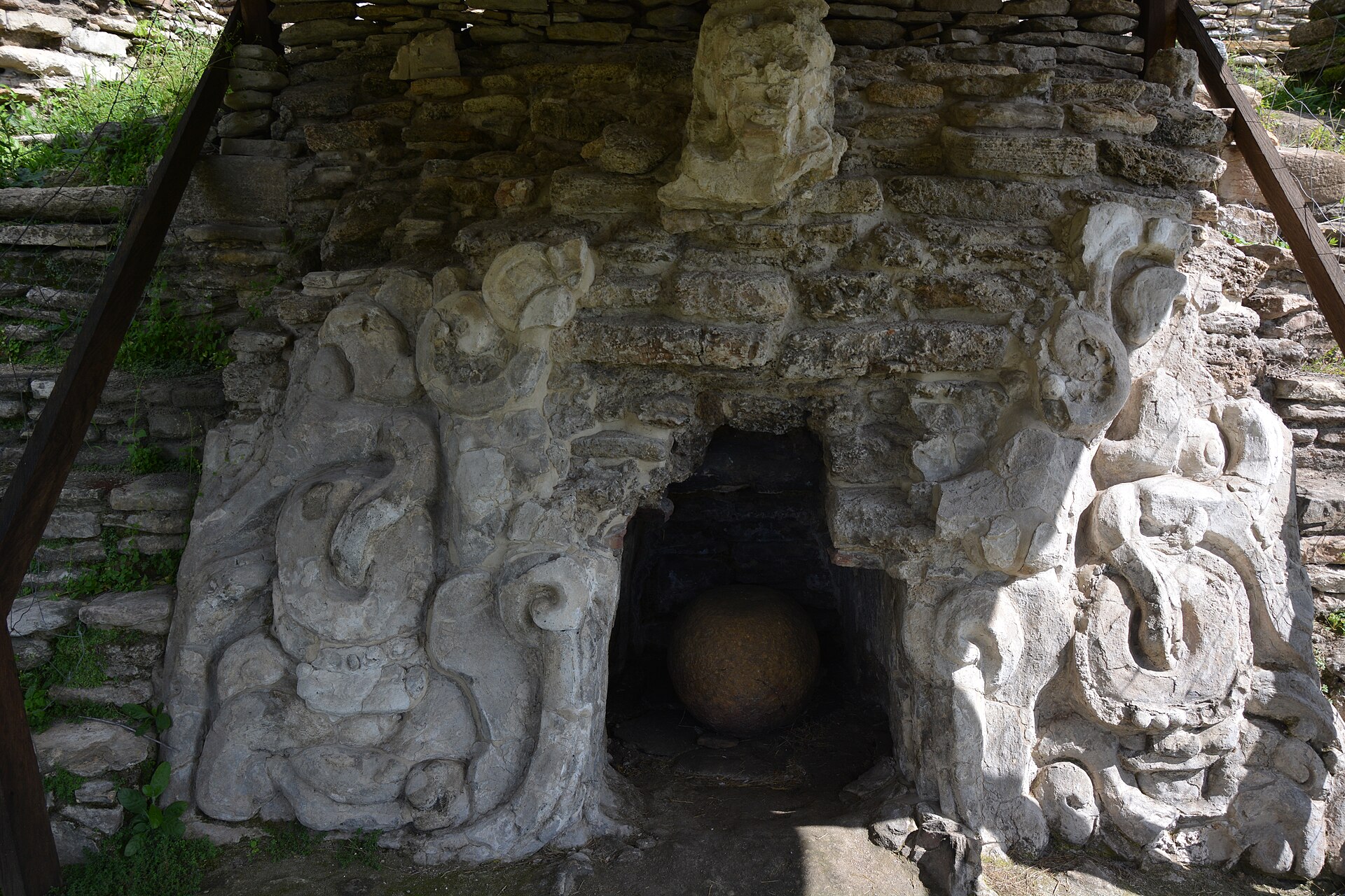 A weathered stucco relief on an upper terrace at Toniná, pale modelled plaster showing supernatural figures within a geometric framework A weathered stucco relief on an upper terrace at Toniná, pale modelled plaster showing supernatural figures within a geometric framework