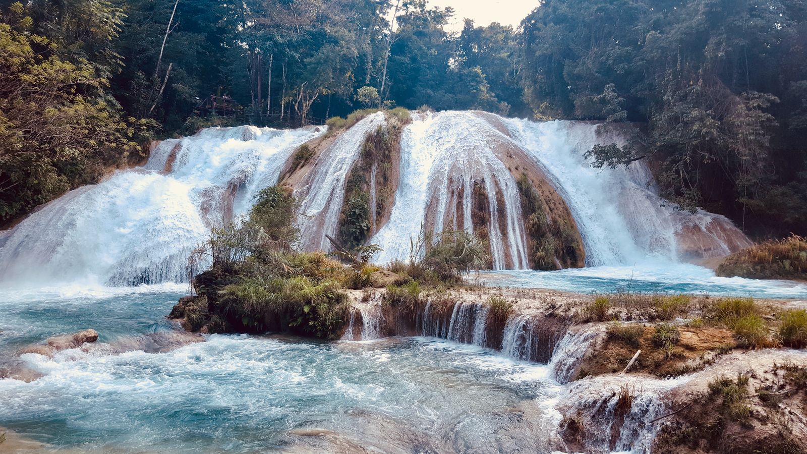 Stepped turquoise cascades flowing over white limestone terraces at Cascadas de Agua Azul Stepped turquoise cascades flowing over white limestone terraces at Cascadas de Agua Azul