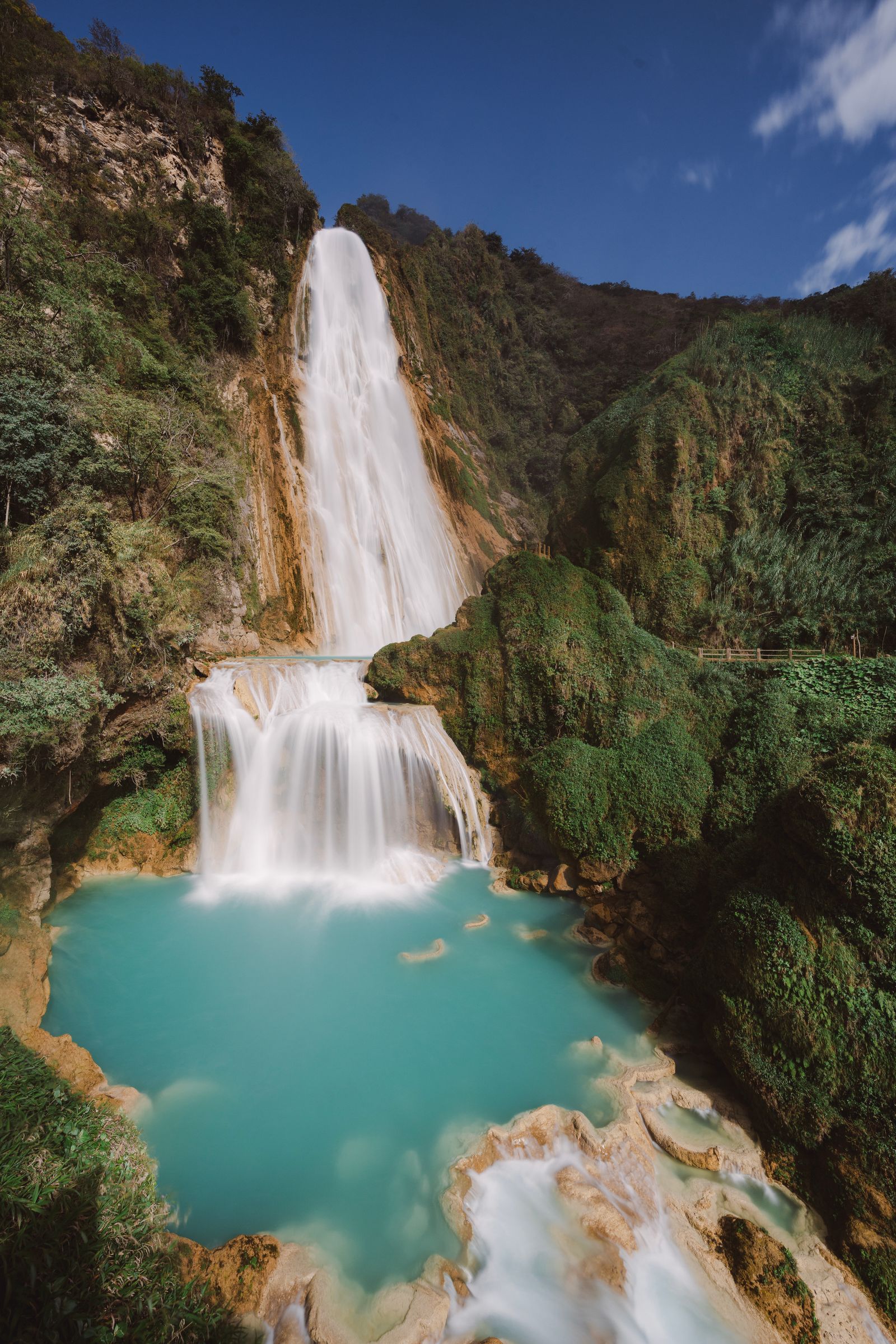 The tall Velo de Novia plume at El Chiflón dropping against a jungle cliff into the turquoise San Vicente River The tall Velo de Novia plume at El Chiflón dropping against a jungle cliff into the turquoise San Vicente River