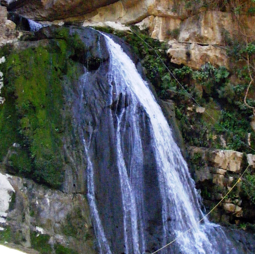 water bursting from the cave mouth at El Chorreadero and dropping into the pools below water bursting from the cave mouth at El Chorreadero and dropping into the pools below