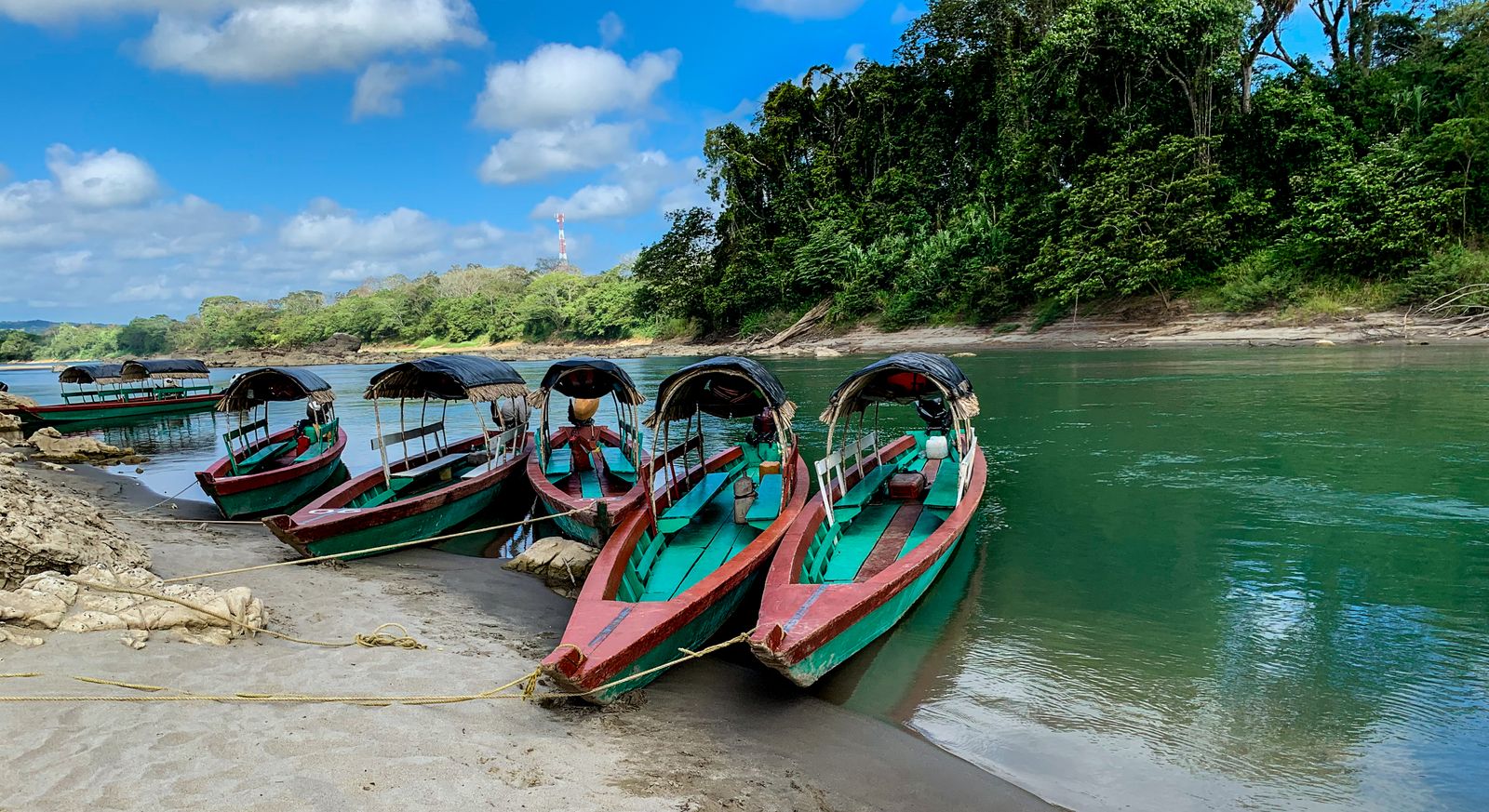 Passenger lanchas moored on the Usumacinta River at Frontera Corozal, the jungle of the Guatemalan bank opposite Passenger lanchas moored on the Usumacinta River at Frontera Corozal, the jungle of the Guatemalan bank opposite