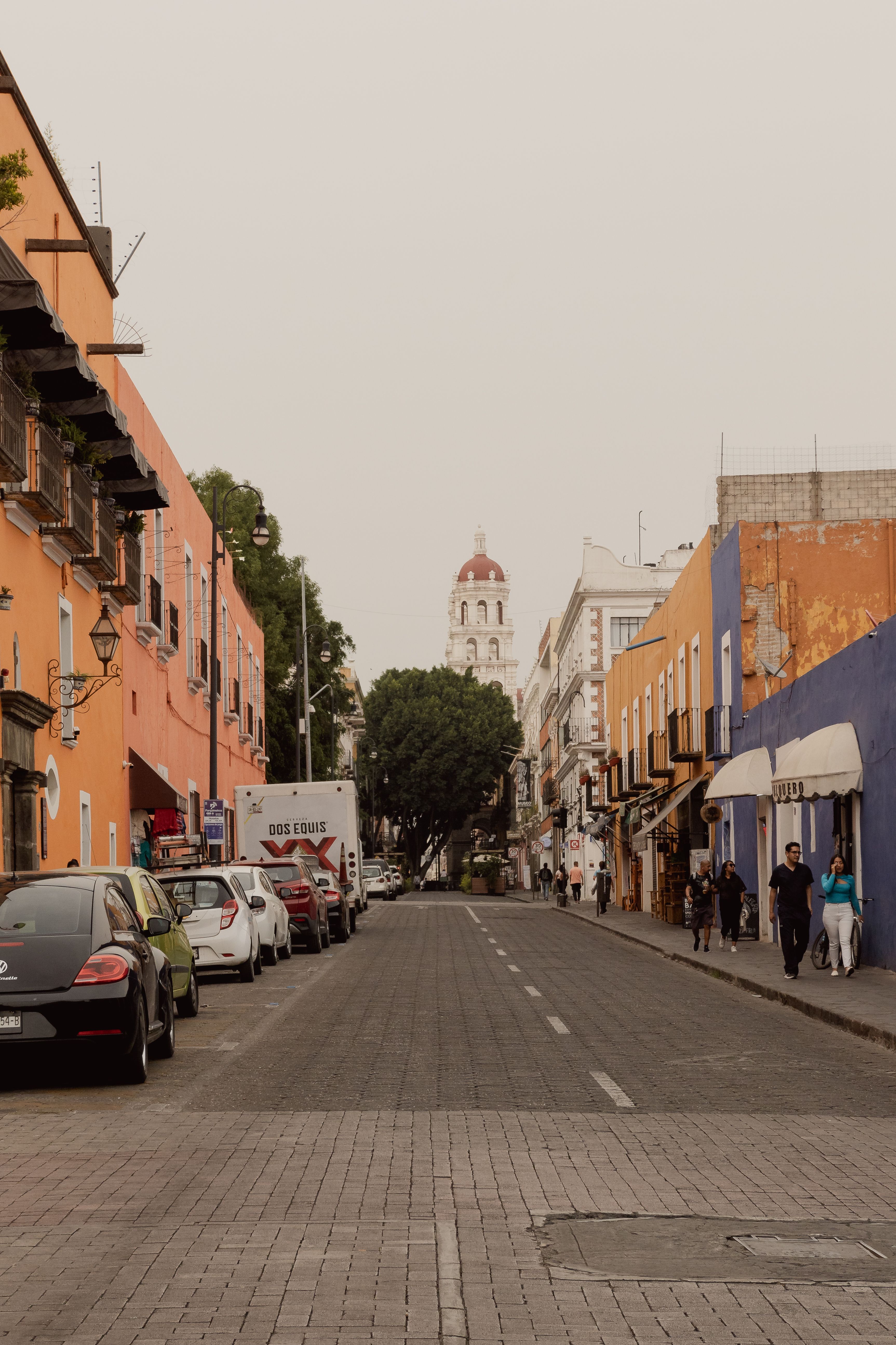 A quiet residential street with low pastel colonial houses in one of Mérida's central barrios A quiet residential street with low pastel colonial houses in one of Mérida's central barrios