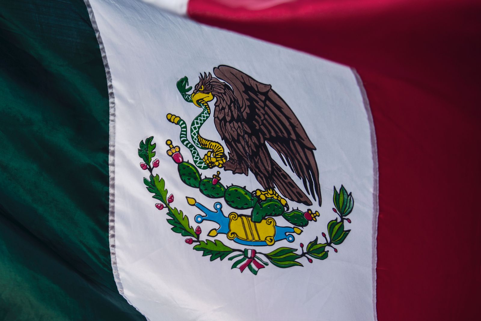 The Mexican flag, its eagle-and-serpent coat of arms in the center
