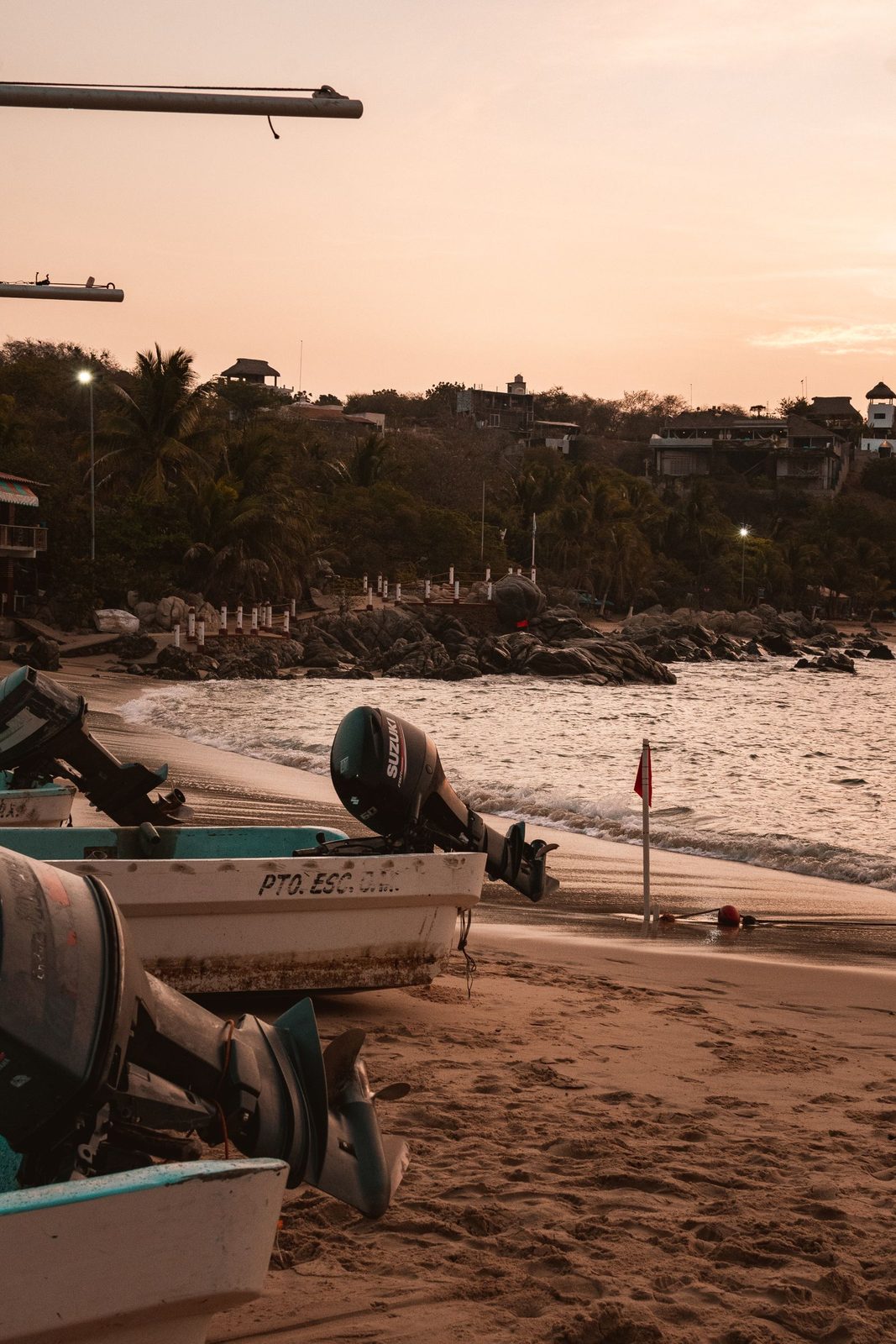 Fishing boats pulled up on the sand in Puerto Escondido at dusk Fishing boats pulled up on the sand in Puerto Escondido at dusk