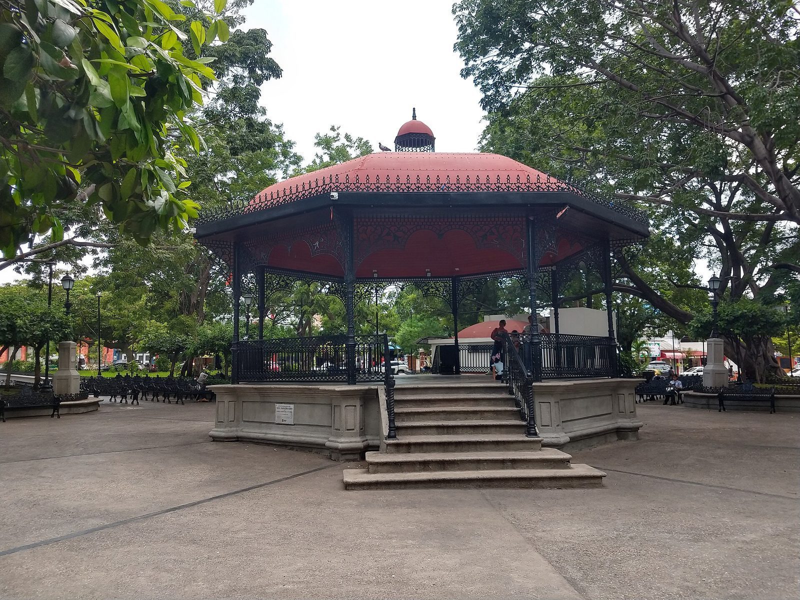 The wrought-iron bandstand at the center of Parque de la Marimba in Tuxtla Gutiérrez, under shade trees