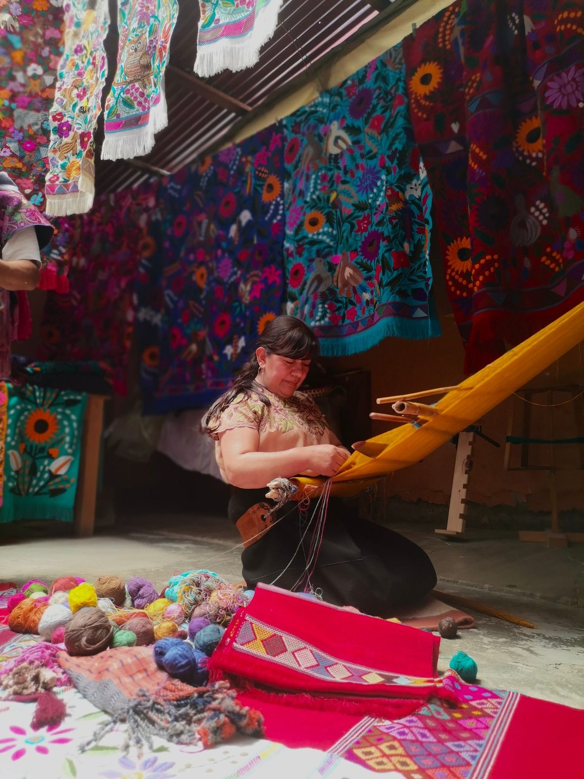 Zinacantec Maya woman weaving textiles on a traditional backstrap loom in Zinacant&aacute;n, Chiapas