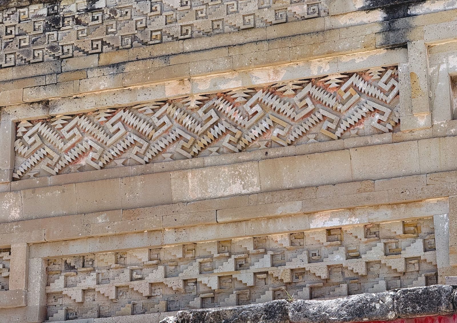 Close-up of intricate geometric mosaic stonework at Mitla, Oaxaca, showing Zapotec fretwork cut into stone