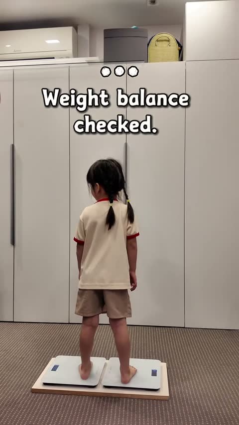 Child standing on two scales for a weight balance check