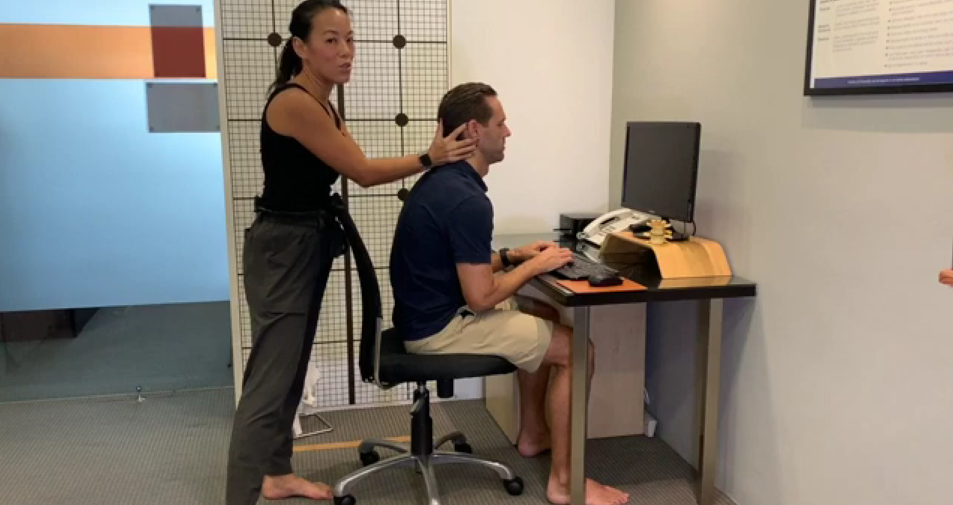 Pinnacle chiropractor assessing a patient at their workstation