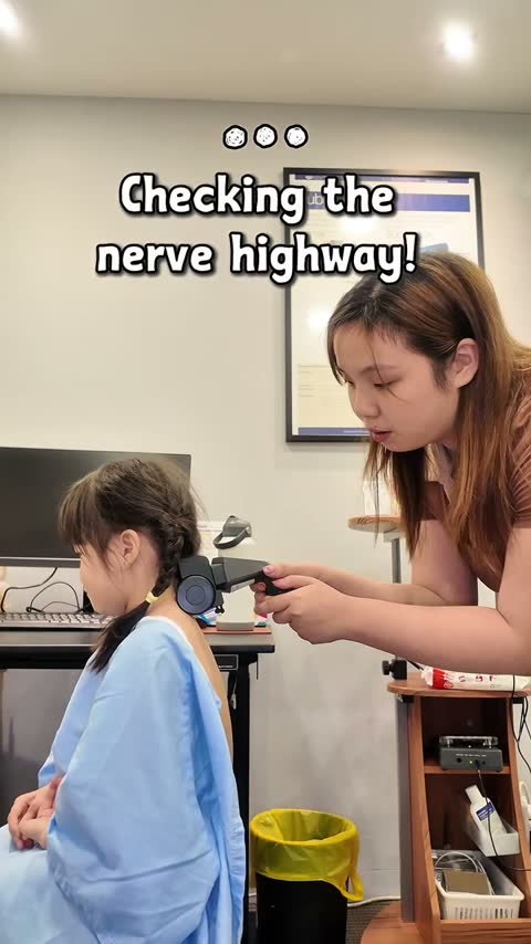 Gentle neurological Insight scan along a child's upper spine
