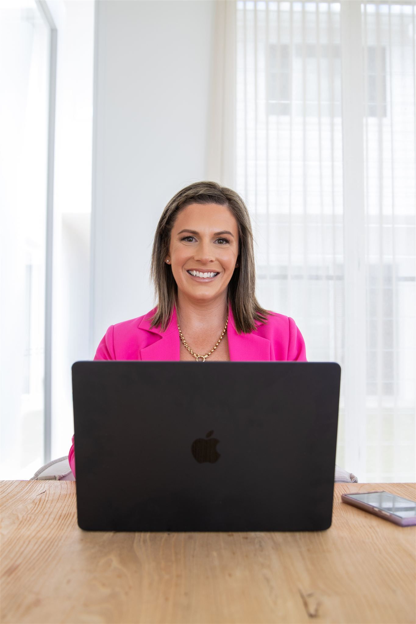 Sinead Brace, GoHighLevel and HubSpot CRM specialist, working at her laptop
