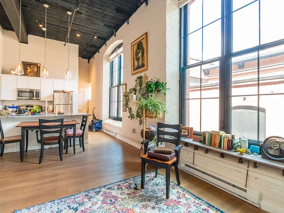 Living and dining area with arched mill windows