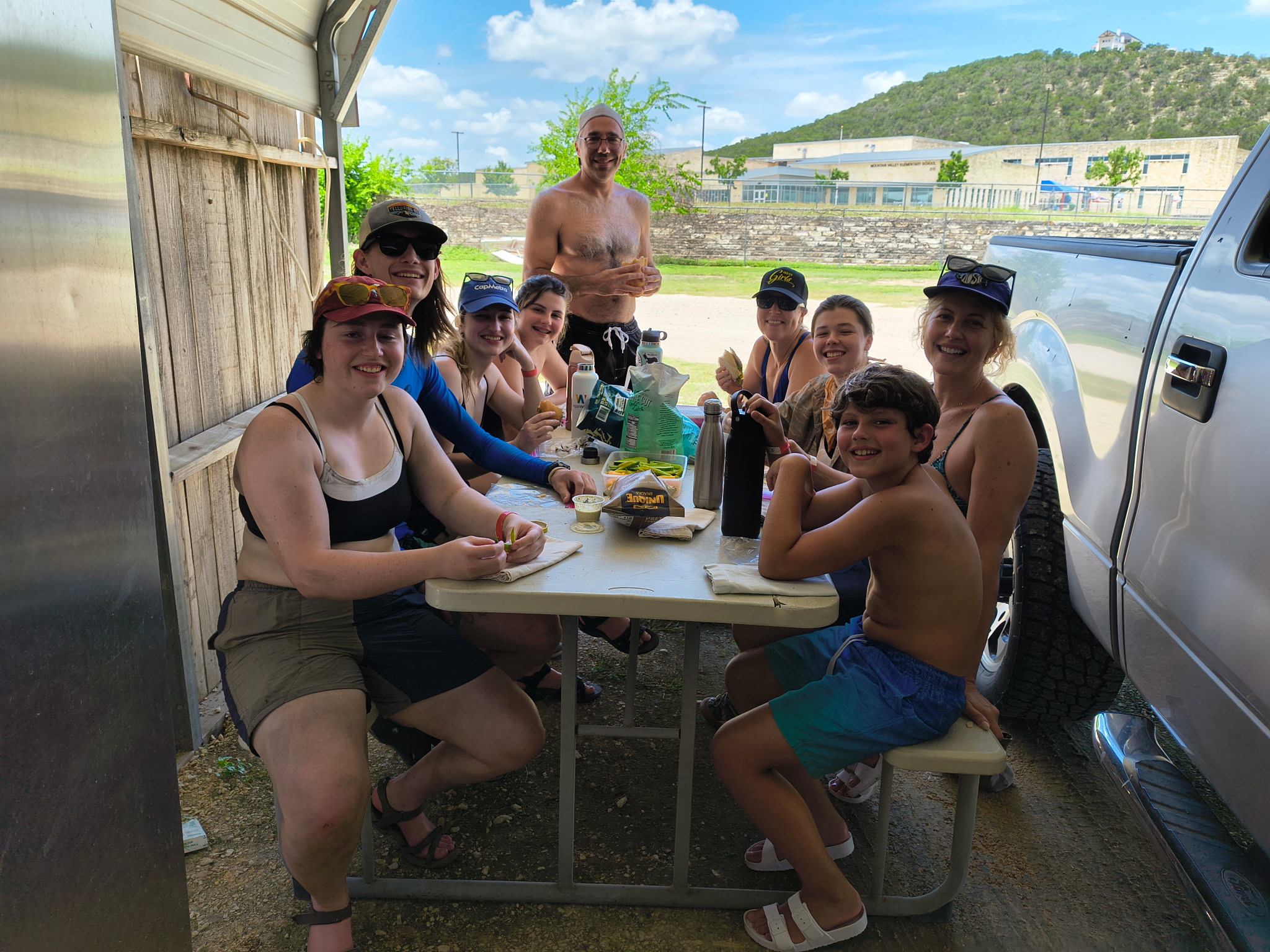 Families gathering at Tube Haus picnic area before floating the river in Canyon Lake, Texas.