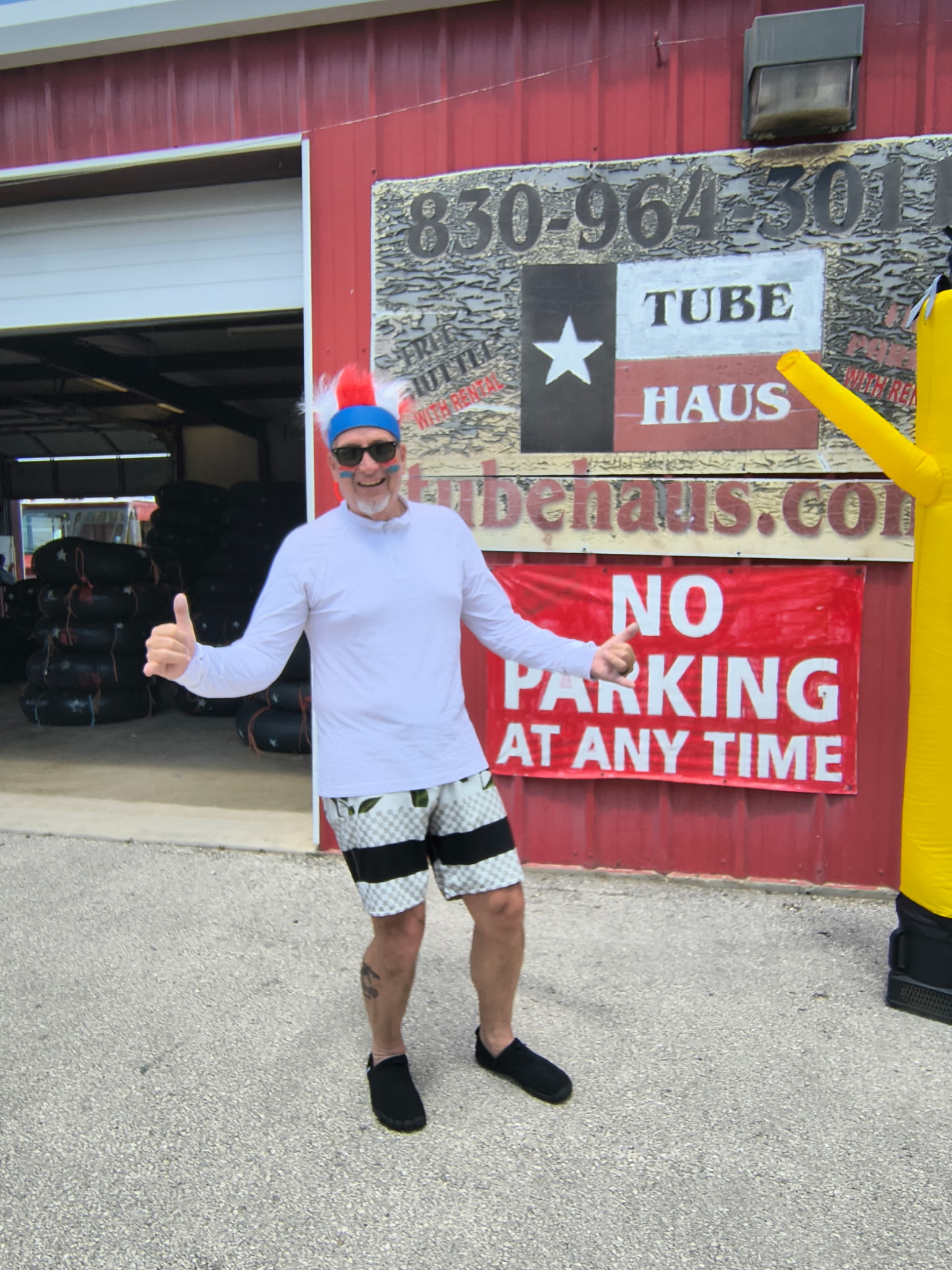 Happy guest arriving at Tube Haus, a river tubing outfitter near Canyon Lake, Texas, ready for a day on the water.