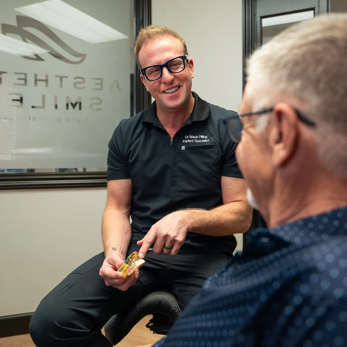 Dr. Wade Pilling explaining dental implants to a patient