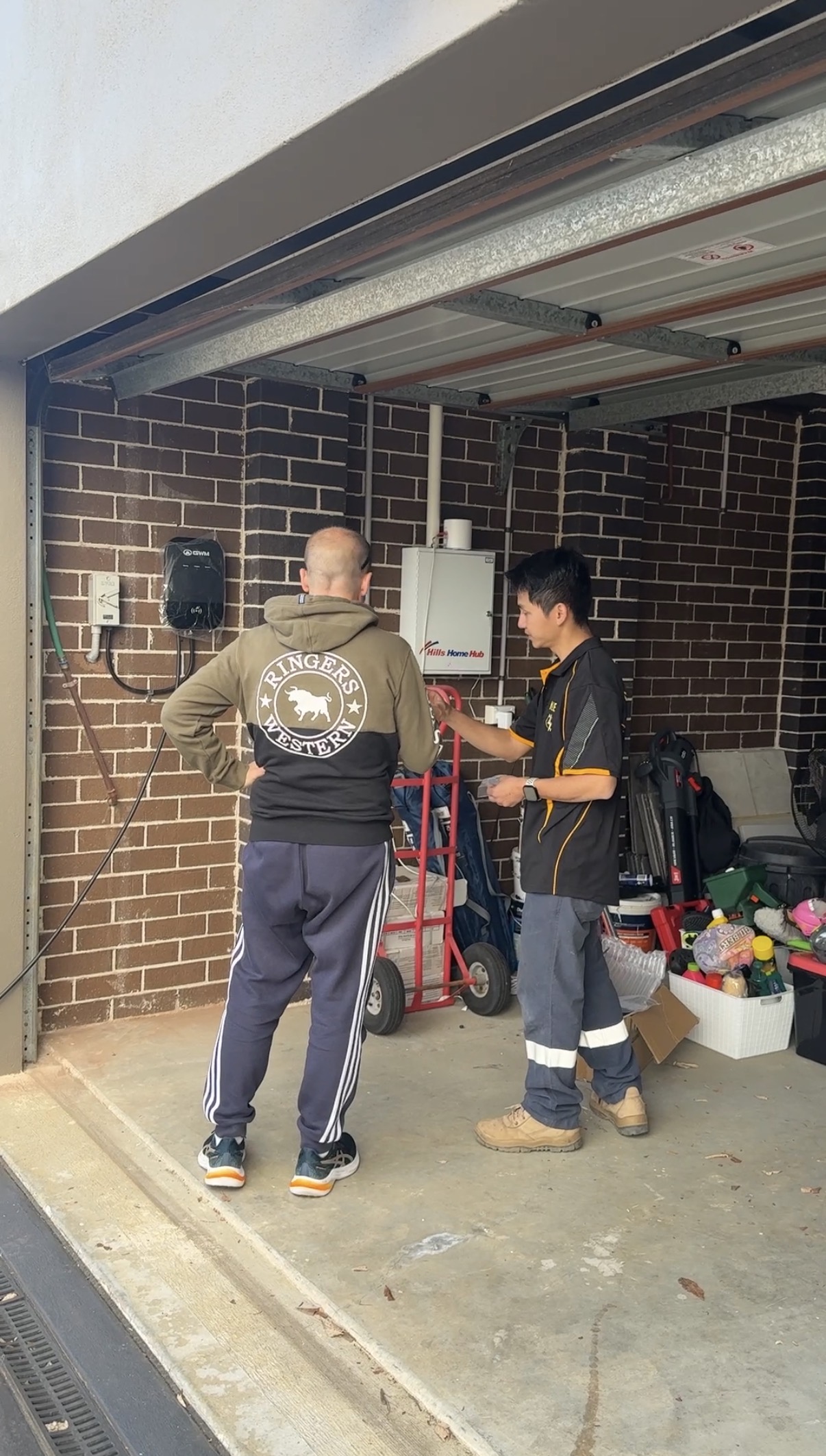 Quang installing an EV charger for a campaign customer