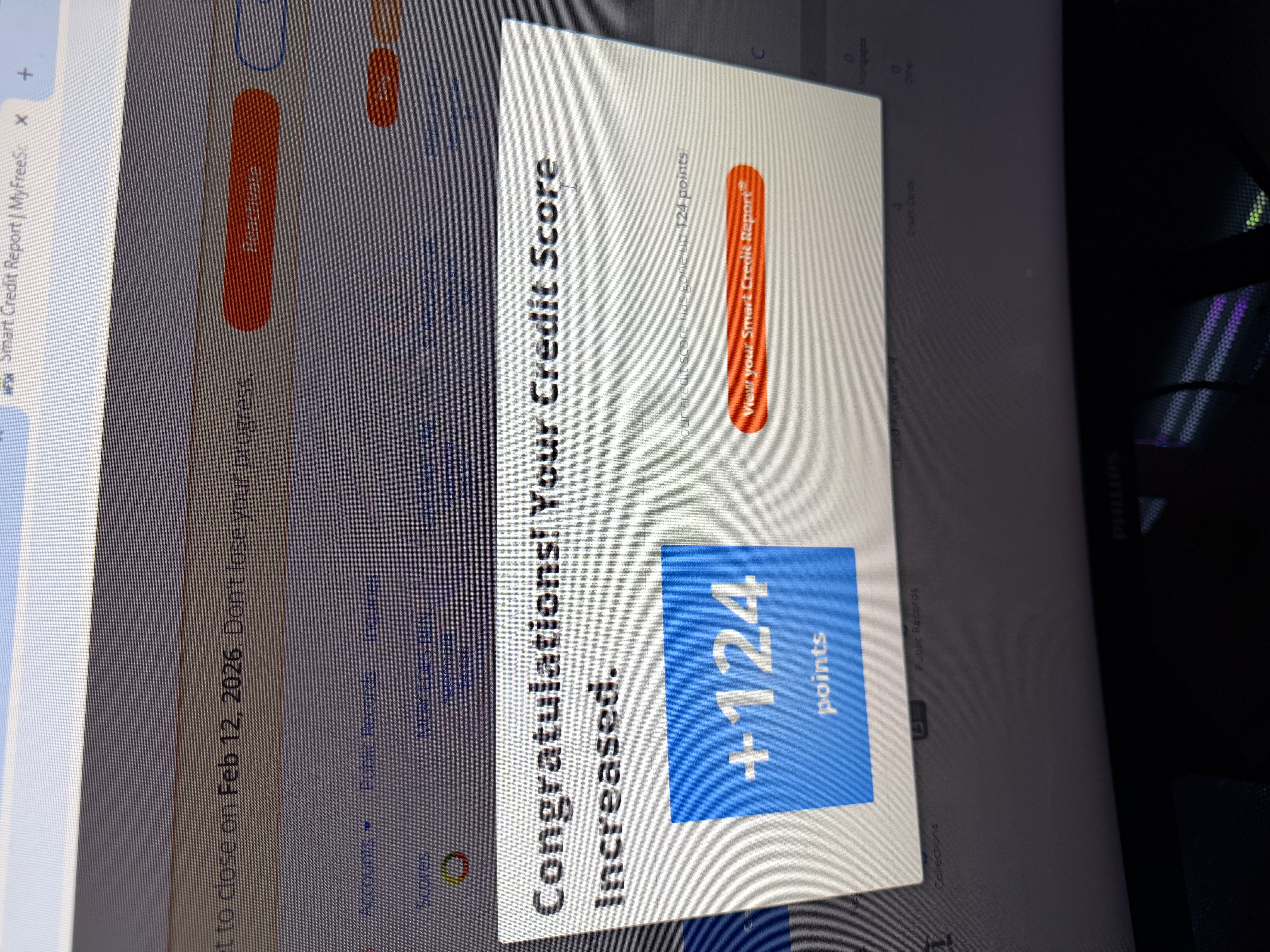 Client credit monitoring app notification showing a 124 point score increase