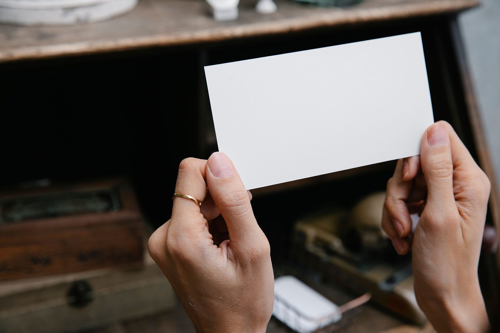Hands holding up a blank card, ready to hand to a buyer