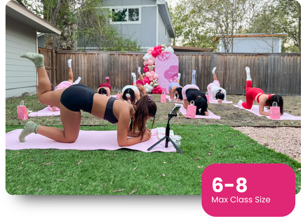 Portrait of a mid-30s female trainer smiling in a softly lit studio.