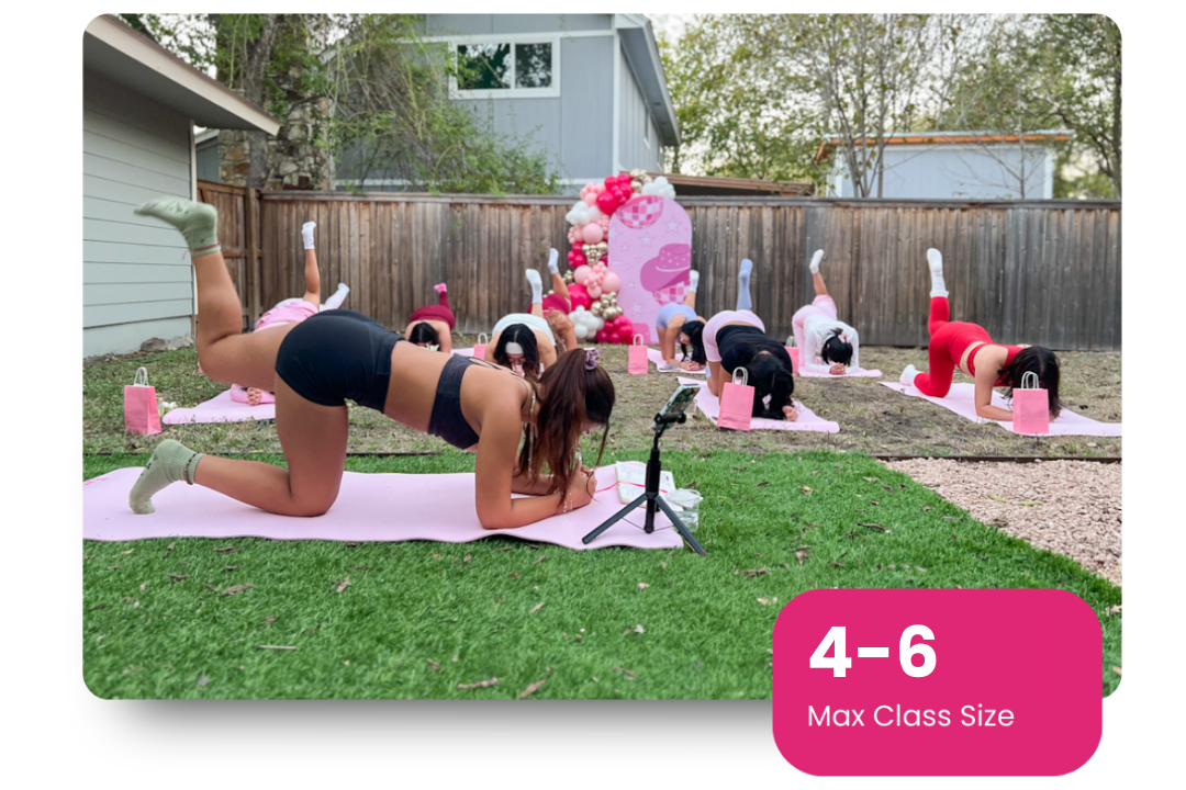 Portrait of a mid-30s female trainer smiling in a softly lit studio.
