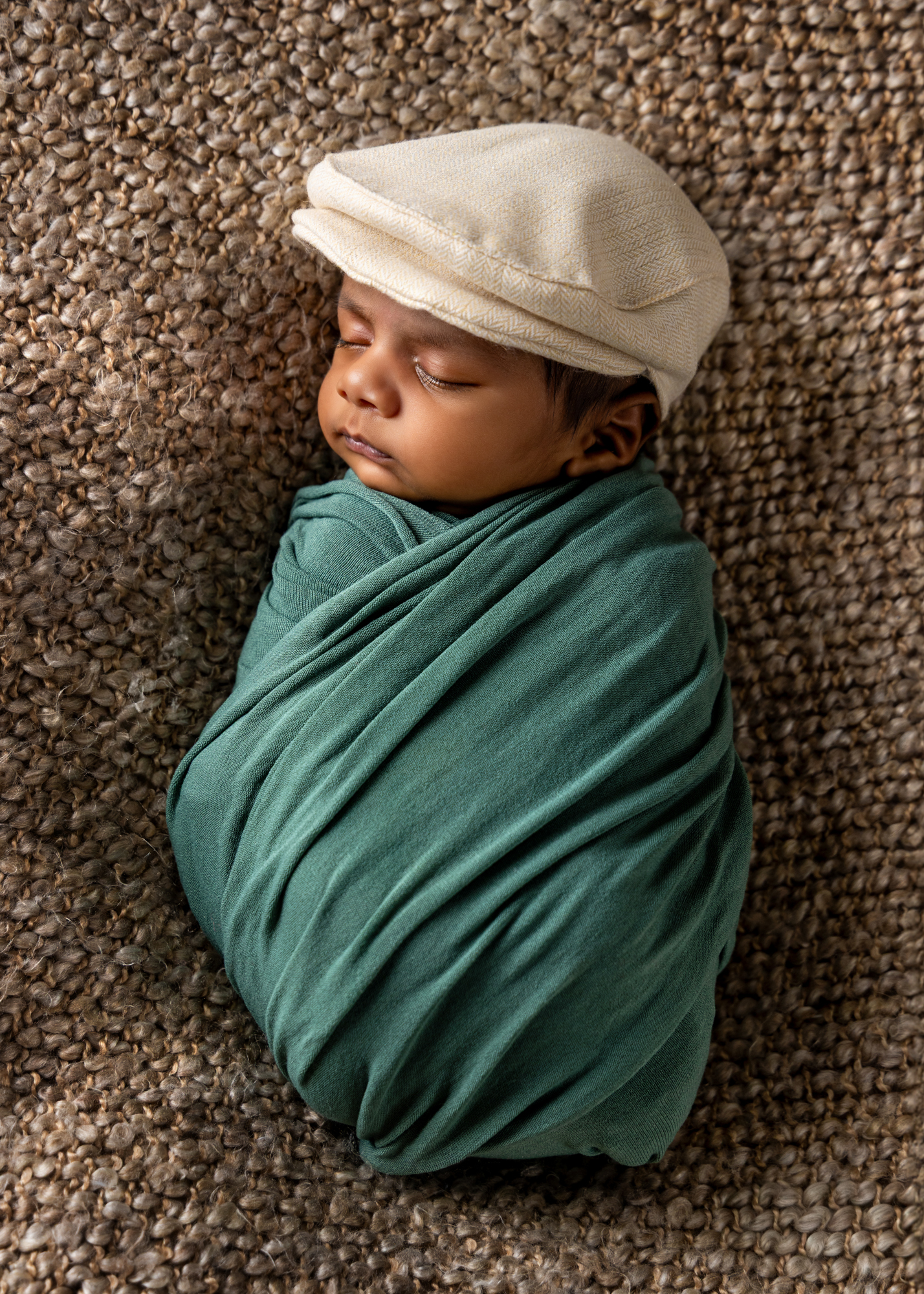 Gentle natural window light illuminating a family holding their newborn baby