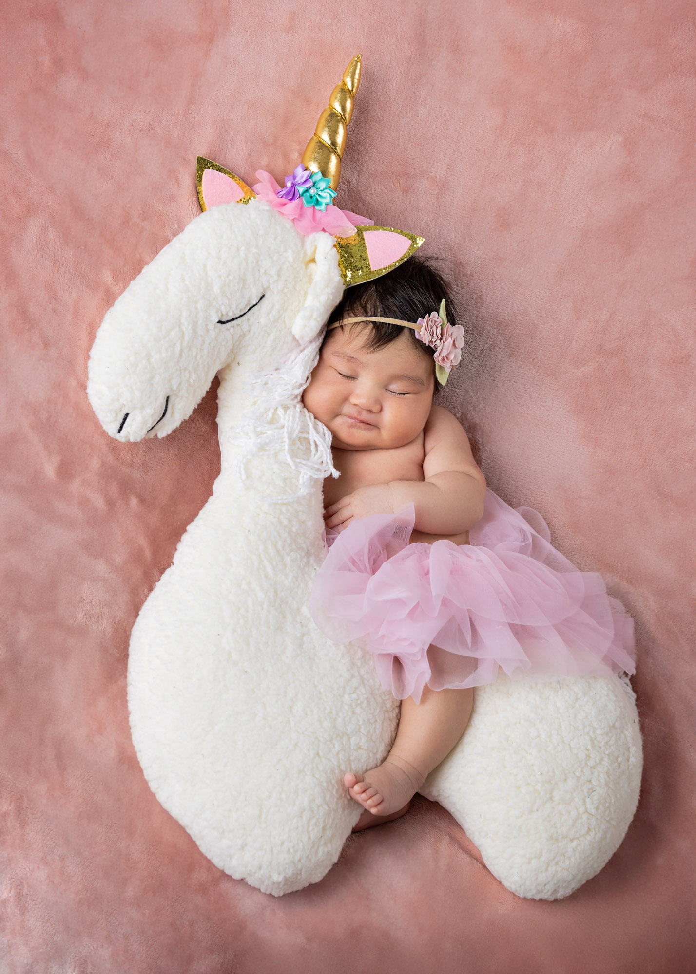 Lifestyle newborn session capturing baby nestled securely in parents arms