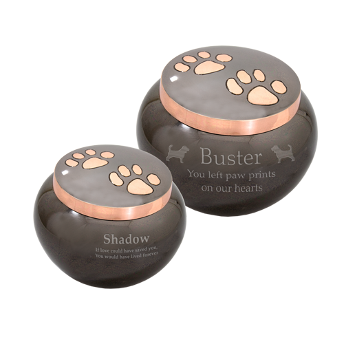 Brass pet urns with copper paw-print accents