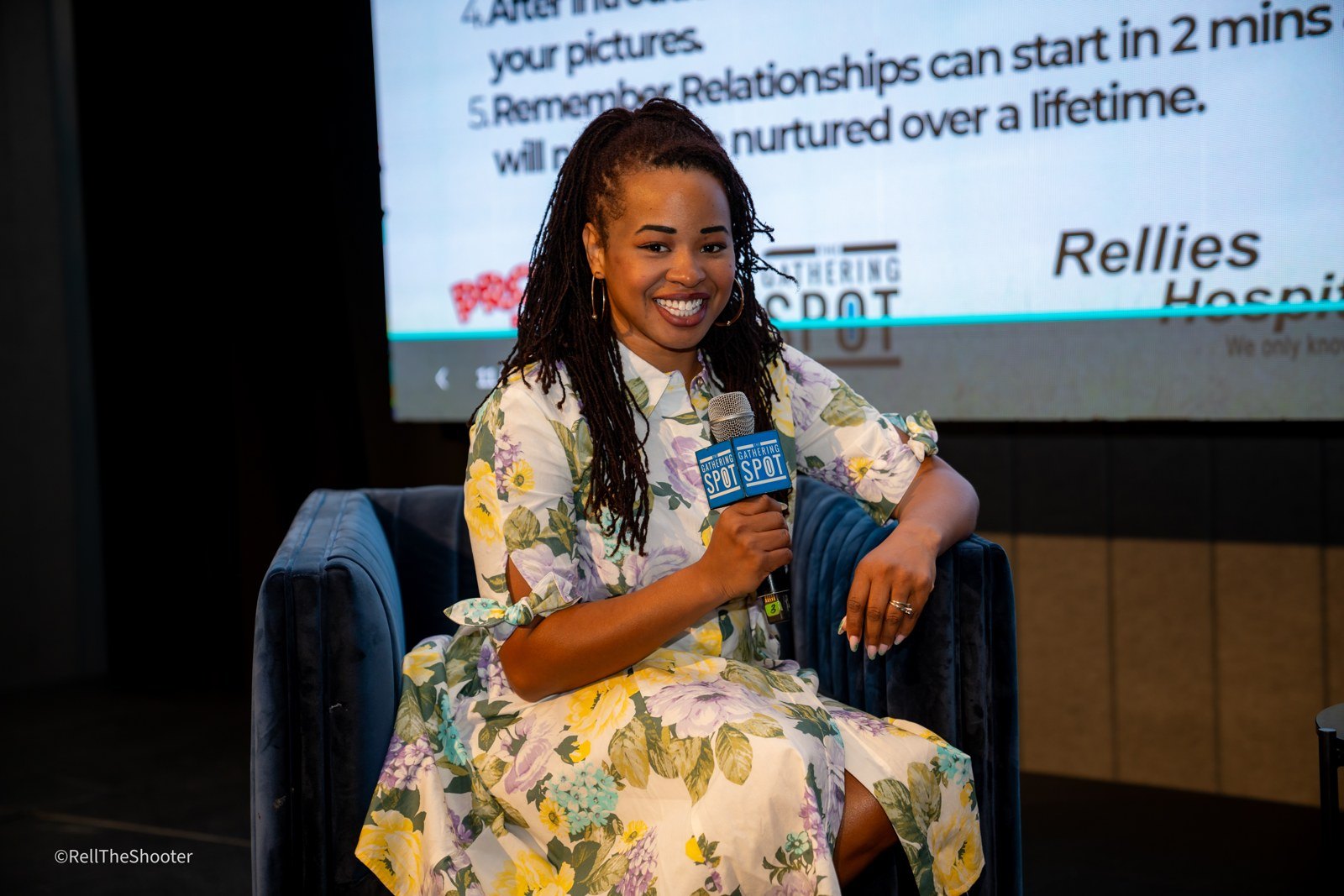 Jessica A. Ross smiling on stage with a JAMGOOD NEWS mic