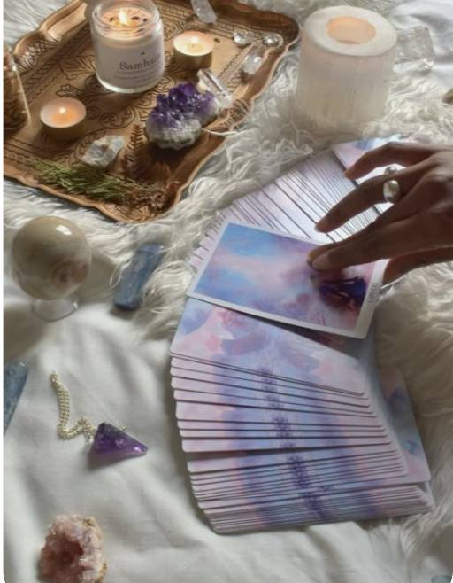 Tarot cards, candles, crystals, and journal ritual tools