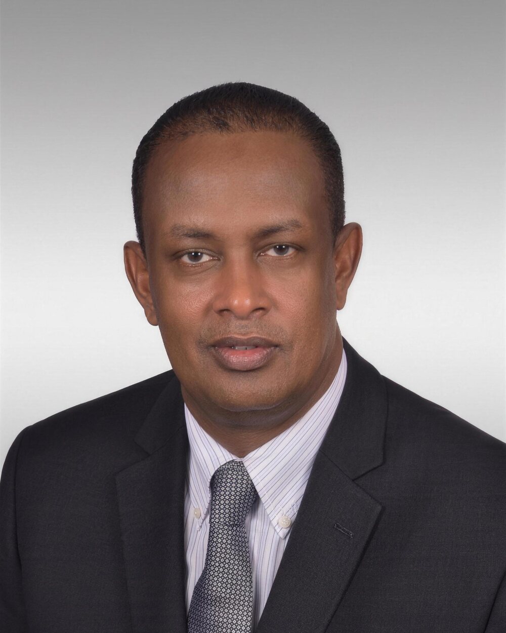 Portrait of Hon. Abdikadir Bush Durow in a dark suit and tie