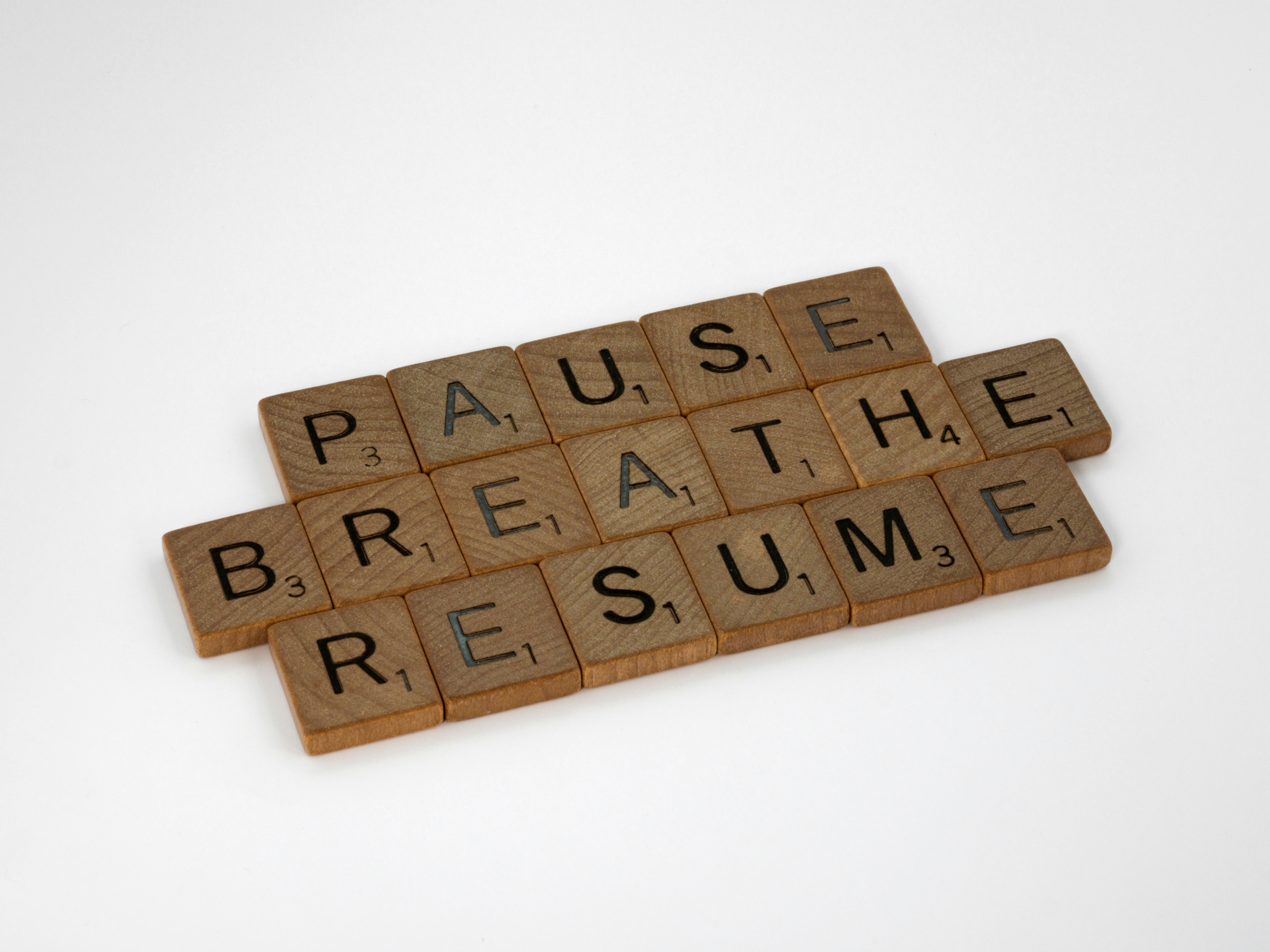 wooden letters: pause - breathe - resume wooden letters: pause - breathe - resume
