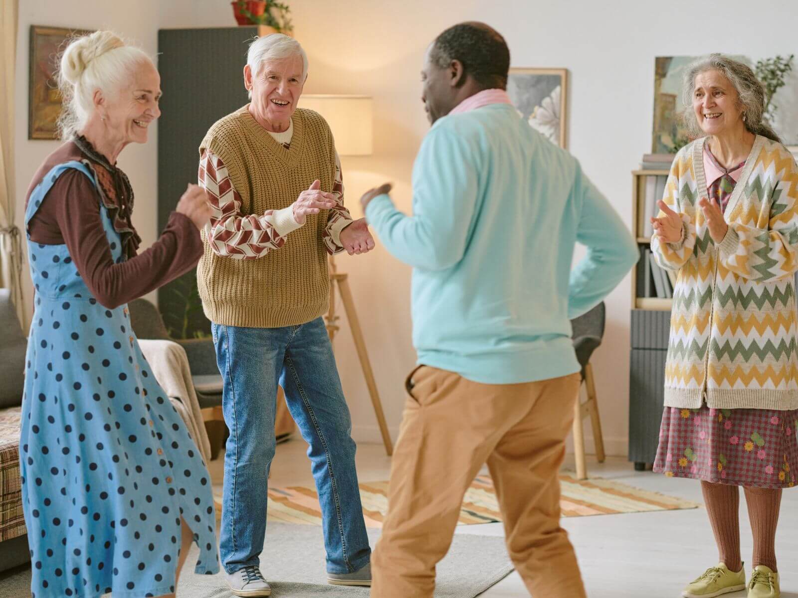 Four Elderly people happily dancing