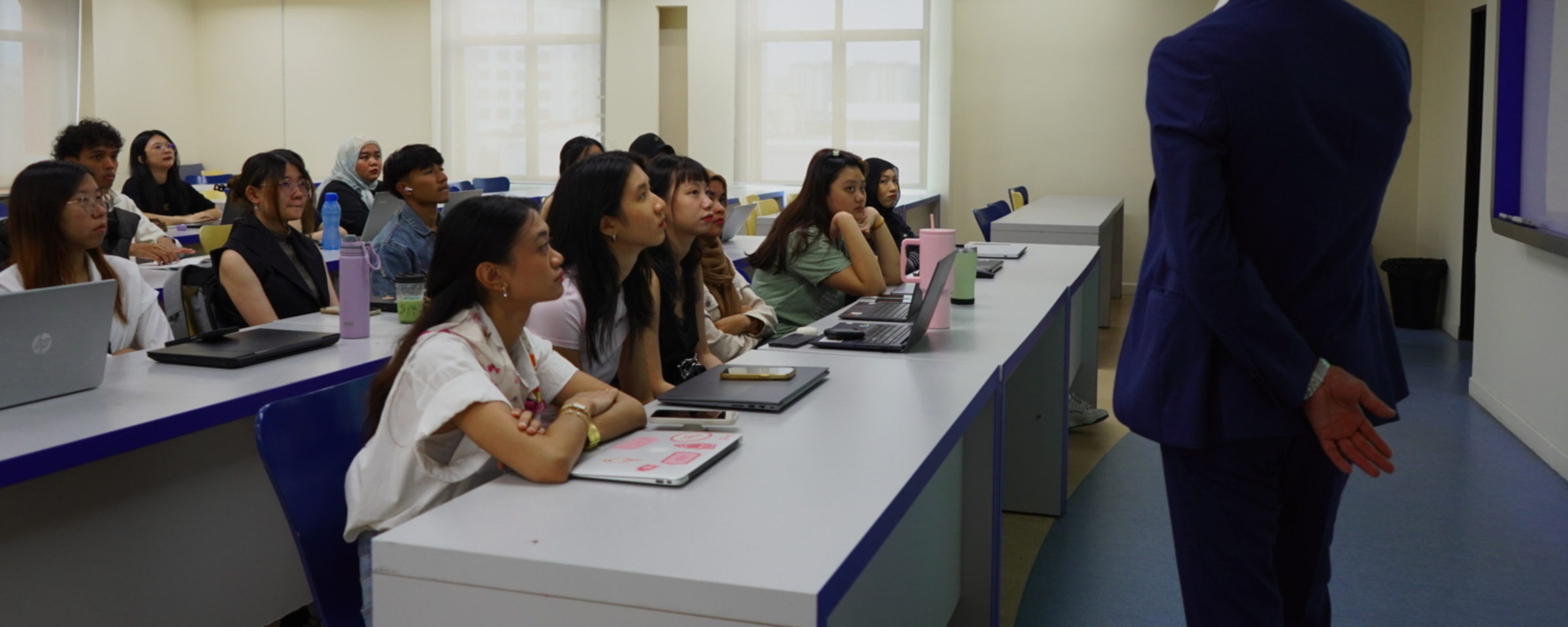 Ryan Tadjou addressing a full classroom