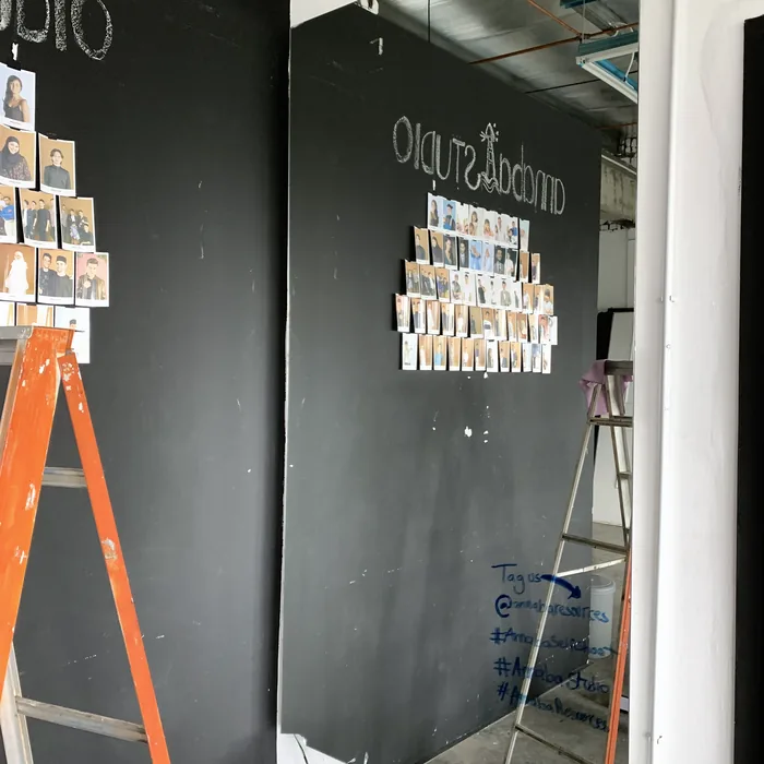 Studio wall and signage being installed during the build