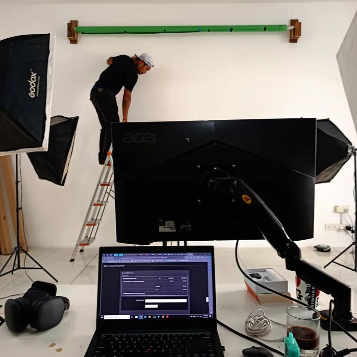 Crew rigging a lighting bar and softboxes in the studio