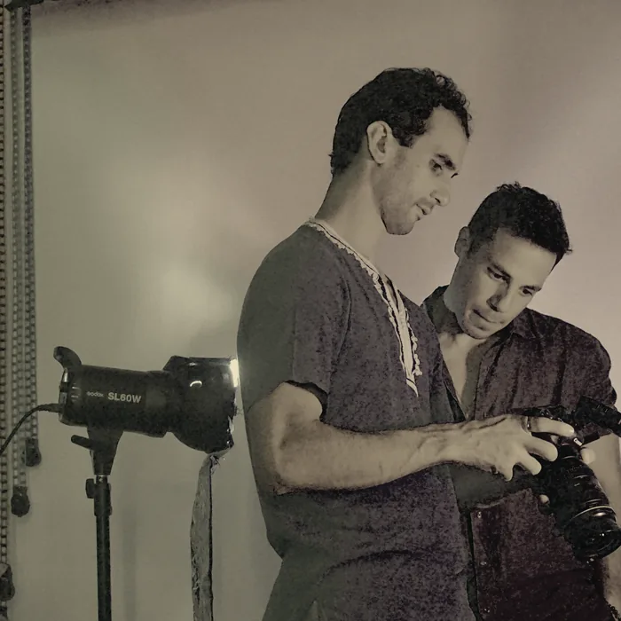 Crew reviewing a shot under gel lighting on a studio set