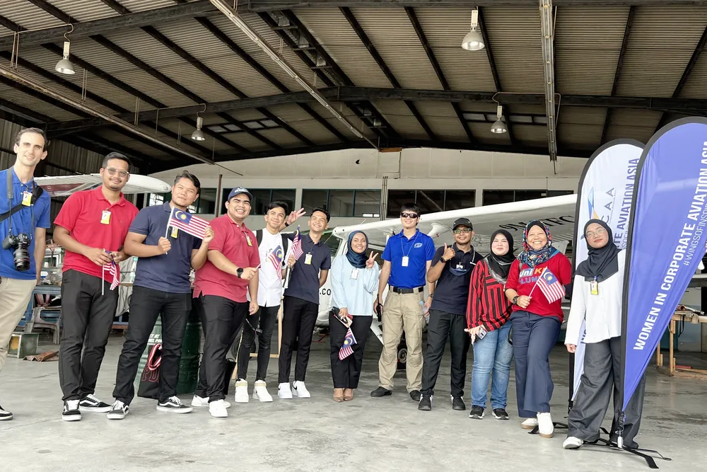 Event team and participants gathered at a corporate activation in an aircraft hangar