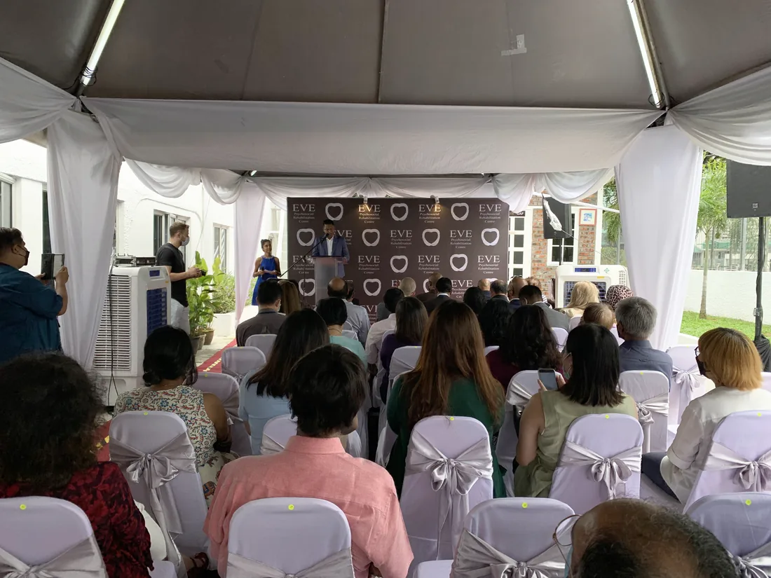 Marquee event staged with seating and a branded backdrop, guests in place